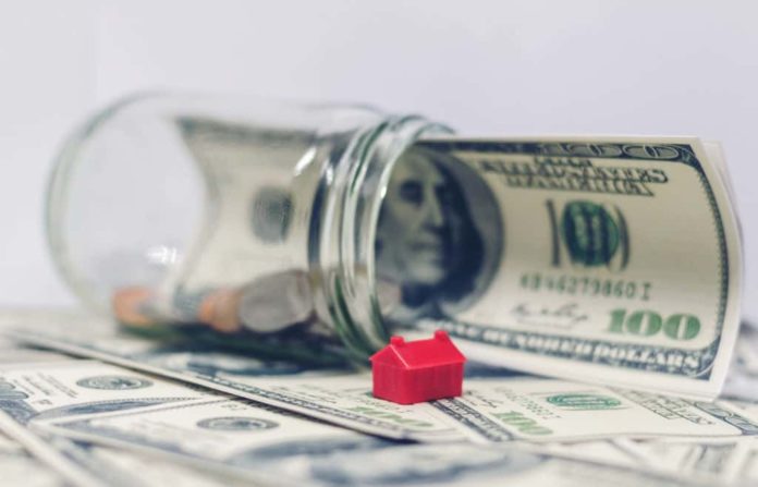 A one hundred dollar bill inside a jar.
