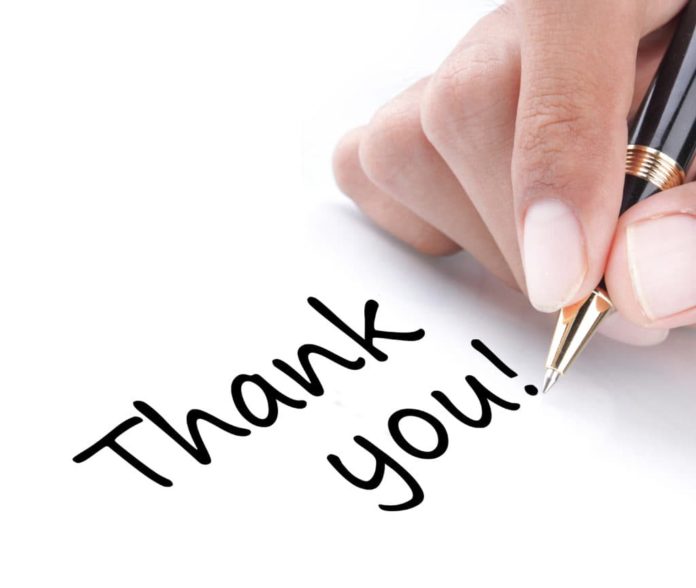 Thanks-for-The-Legacy The-True-Meaning-of-Thanksgiving A person writing thank you to their family.