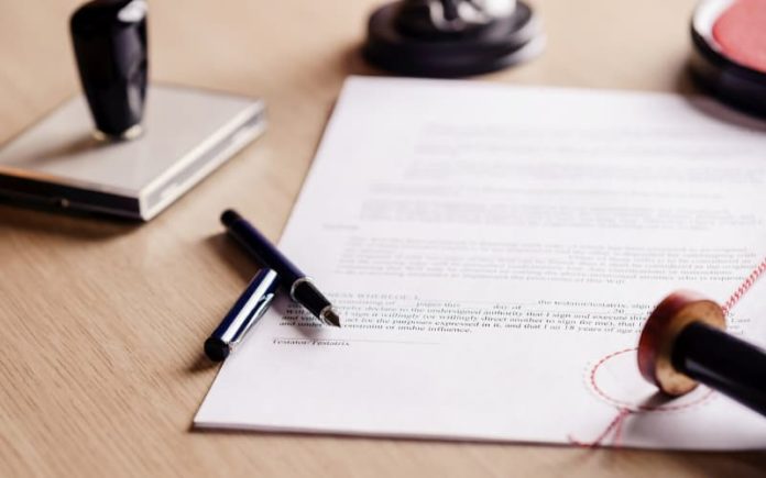 Three things to do on the death of a loved one Personal legal documents laid on a table.