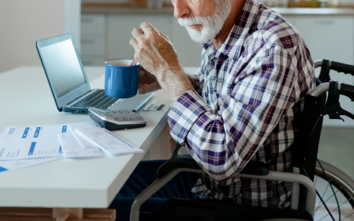 Investment Firms on Cutting Age of Dementia Problem elderly man sitting in front of a computer