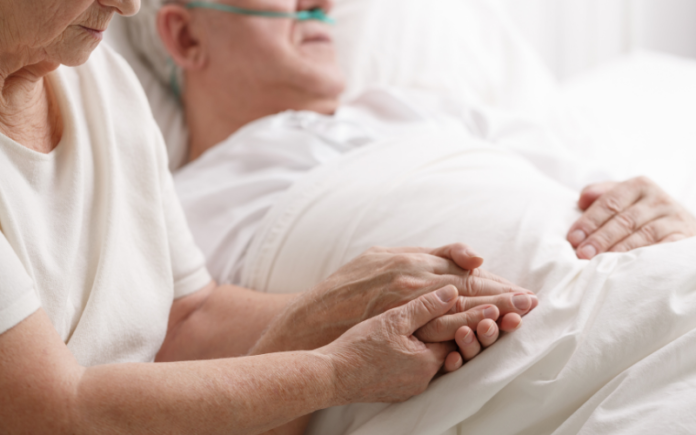 woman holding sick man's hand