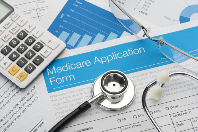 Medicare application form with stethoscope and paperwork