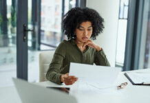lady sitting at table going over paperwork