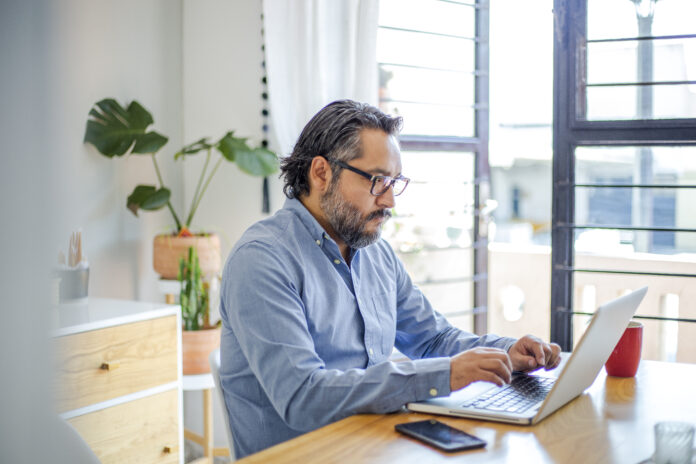 man using laptop at home