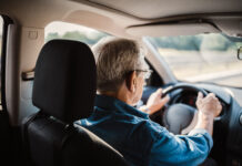 Senior man driving car on the highway