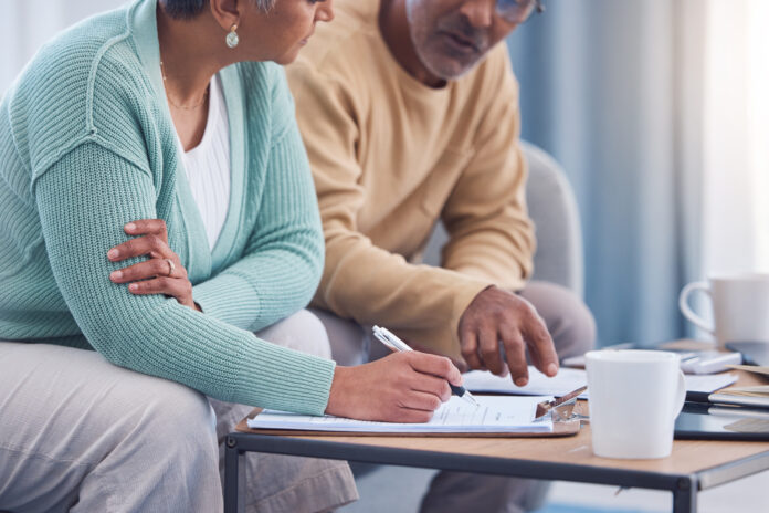 Senior couple, documents and sign contracts.