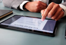 Man signs digital last will online, ensuring legal documentation recorded.