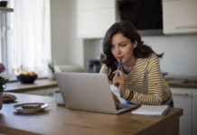 Young woman using a laptop while working from home
