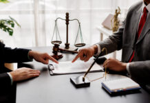 The boss is pointing in the face at the helper who misbehaved in business or legal matters in law firm office. Legal law, advice deal justice and law concept.